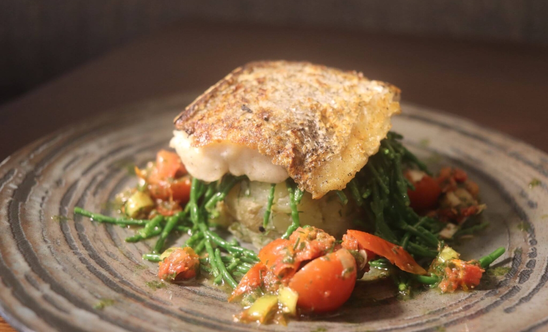Grilled Atlantic Hake with lemon infused potato cake, sea greens and salsa Verde