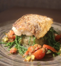 Grilled Atlantic Hake with lemon infused potato cake, sea greens and salsa Verde