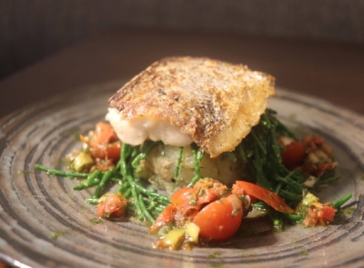 Grilled Atlantic Hake with lemon infused potato cake, sea greens and salsa Verde