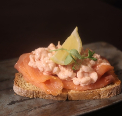 Open-sandwich on sourdough bread topped with smoked salmon prawns and Marie Rose sauce