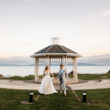 Romantic sunset wedding by the sea with a scenic gazebo