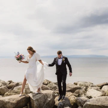 A beautiful coastal wedding venue with a sea view, elegant decorations, and trees, creating a romantic atmosphere for a perfect outdoor ceremony.