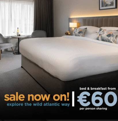 Image of a promotional sign displaying "Sales now on" with a colorful geometric background, possibly related to a sale or special offer at Connemara Coast Hotel.